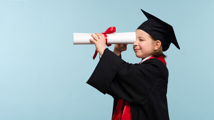 Funny Whizz kid girl wearing graduation cap and ceremony robe on light blue background. Graduate celebrating graduation. Education Concept. Smart child looks to the future through the certificate