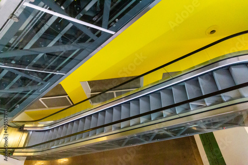 Escalators on a yellow background in a museum