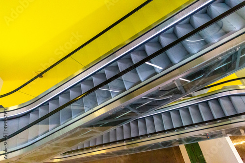 Escalators on a yellow background in a museum