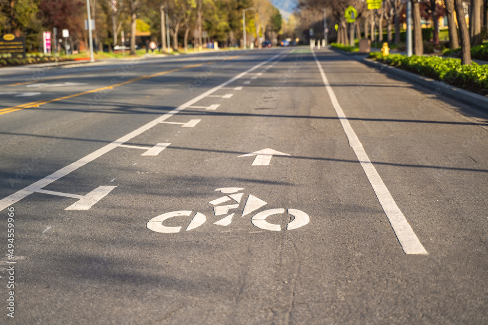 Obraz premium Bicycle path on a city street. A white bicycle symbol on the road.
