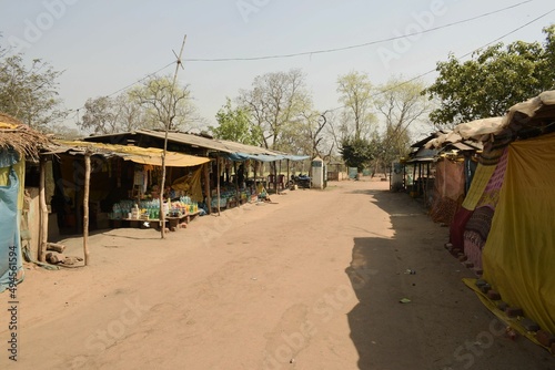 shops by the dirt road under scorching sun