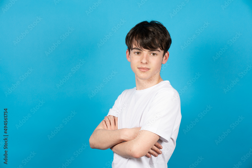 Portrait of confident teenager boy on blue background Portrait of confident teenager boy on blue background