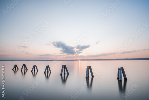Sunset Impression of wooden pillars at Lake Neusiedl (Podersdorf am See, Burgenland, Austria) photo