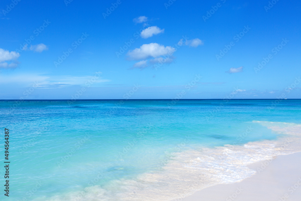 Travel background with white sand beach and Caribbean sea.
