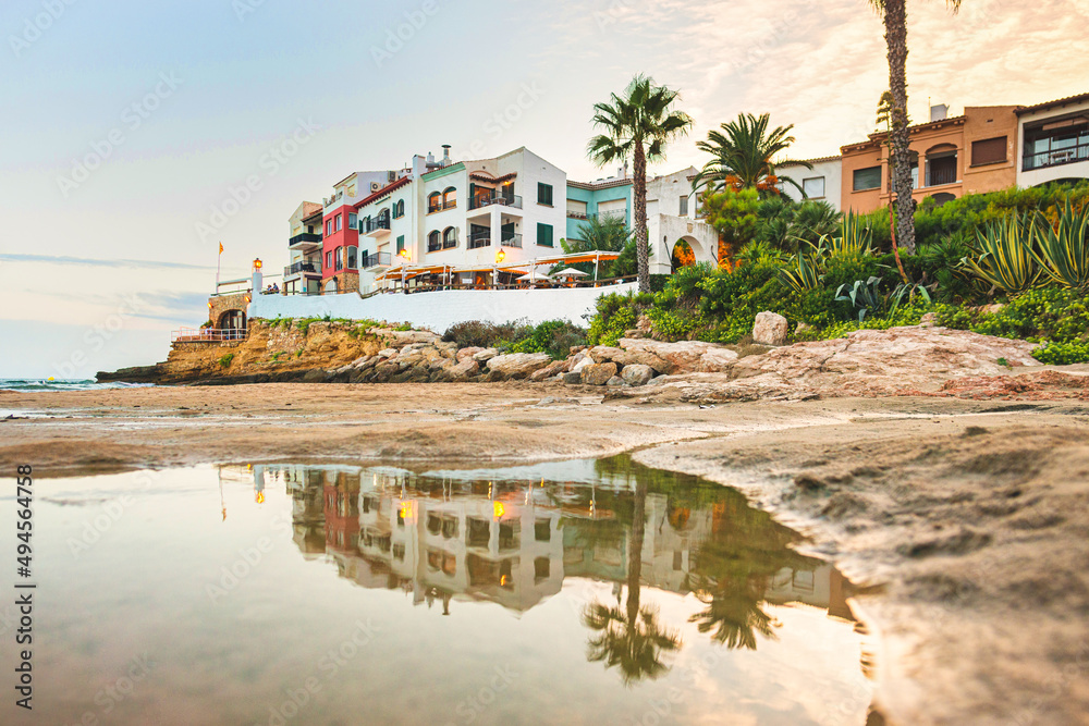 Fototapeta premium Beautiful white houses, mediterranean sea and a clear blue sky in the setting sun and sunset in El Roc de Sant Gaieta, Catalonia