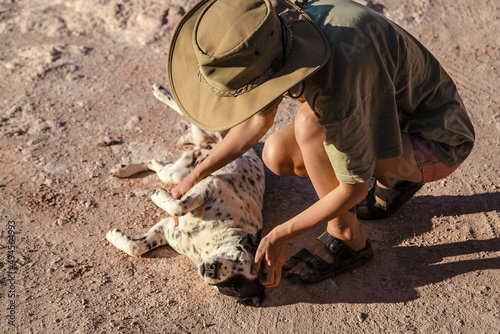 Person patting dog in the desert of Coober Pedy, South Australia photo