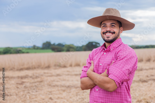 Portrait of a proud Latin American farmer standing with his arms crossed  looking at the camera.