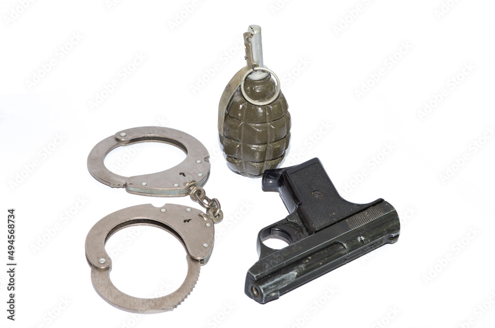 Obraz premium weapons, handcuffs, pistol, grenade on a white background