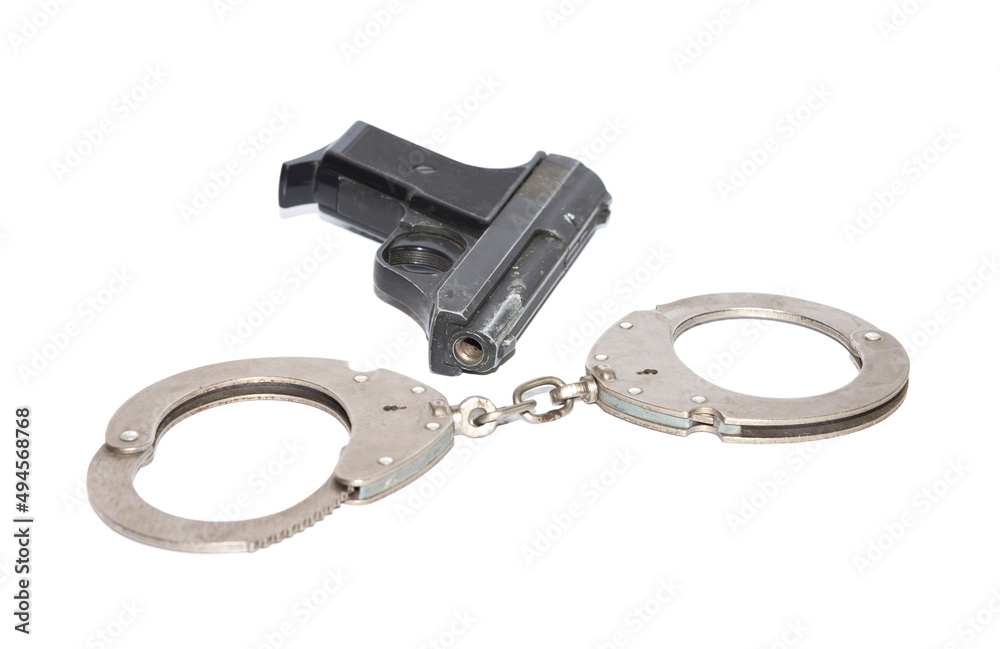 Obraz premium weapons, handcuffs and a gas pistol on a white background