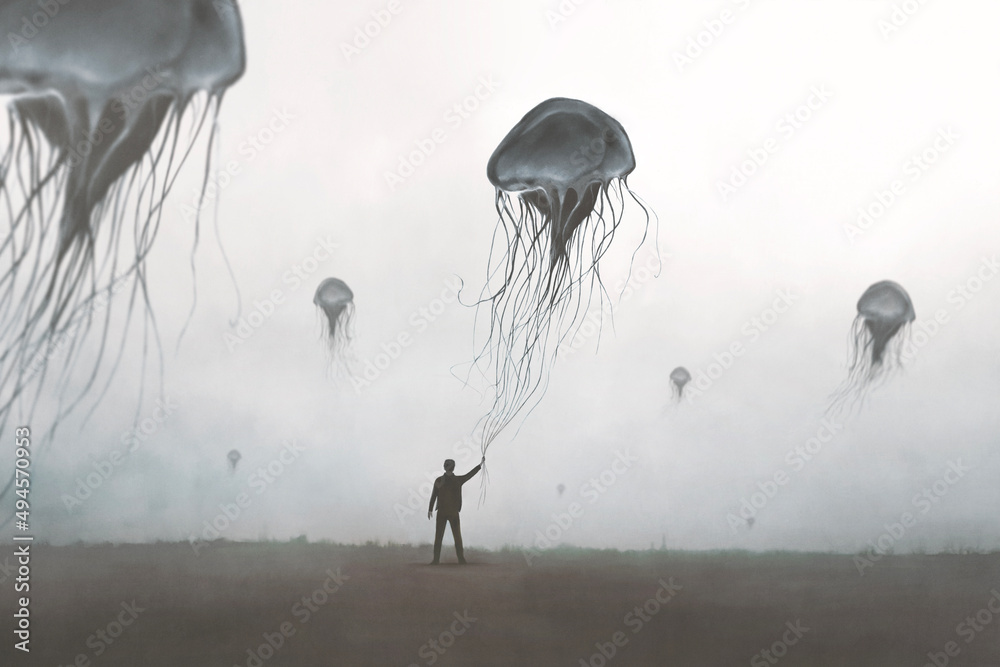 Illustration of man holding big jellyfish blowing in the air among many others, abstract fantastic dreamy concept - obrazy, fototapety, plakaty 
