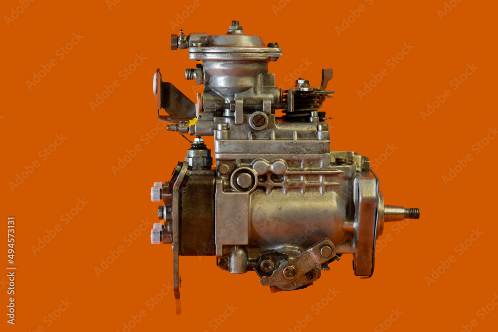 Reconditioned diesel car high pressure pump on a white background. Automotive diesel pump, mechanical, from older type car. View of pump from side.