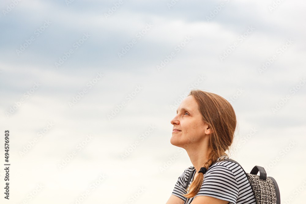 Beautiful girl on the sea with blue sky and clouds