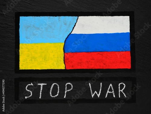 The flag of Ukraine and Russia hand-painted on a black textured background. War between Russia and Ukraine. Stop the war .