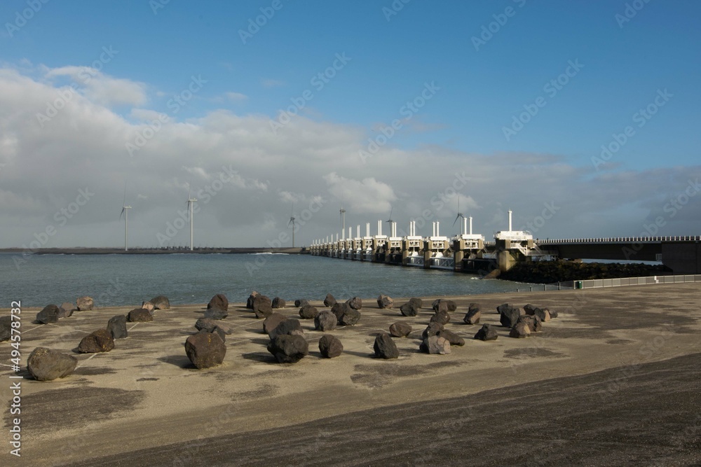 view of the Oosterscheldekering from Neeltje Jans in the province of Zeeland, the Netherlands. This dike serves as a storm surge barrier and protects the Netherlands against flooding during spring tid