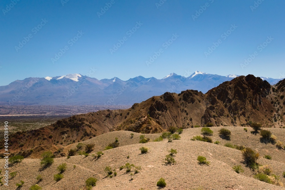 Naklejka premium Arid hills in natural reserve El Leoncito, in the province of San Juan, Argentina. The Andes mountains can be seen in the back.