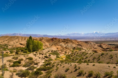 Arid hills in natural reserve El Leoncito, in the province of San Juan, Argentina. The Andes mountains can be seen in the back.