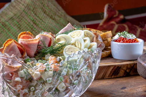 Olivier. Traditional Russian salad of boiled vegetables with meat and mayonnaise in a large salad bowl.