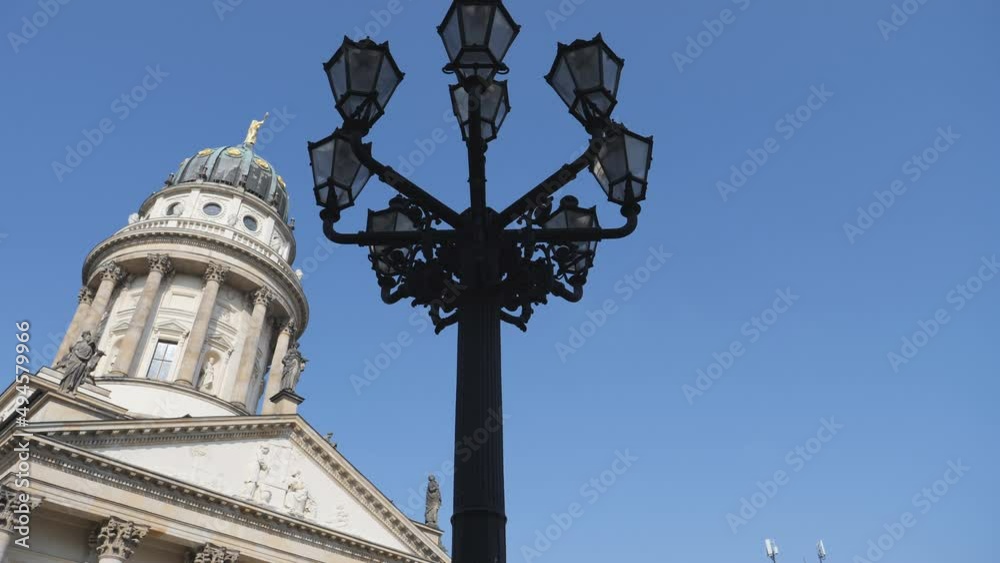 A low angle view of the Franzosischer Dom french cathedral and a street lantern. A low angle view of the Franzosischer Dom french cathedral and a street lantern.