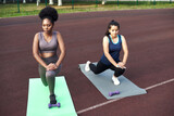 Active lifestyle in the city. Image of young women doing stretching after running workout