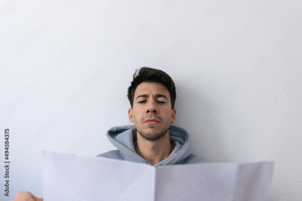 Caucasian man reading an instruction manual Caucasian man reading an instruction manual