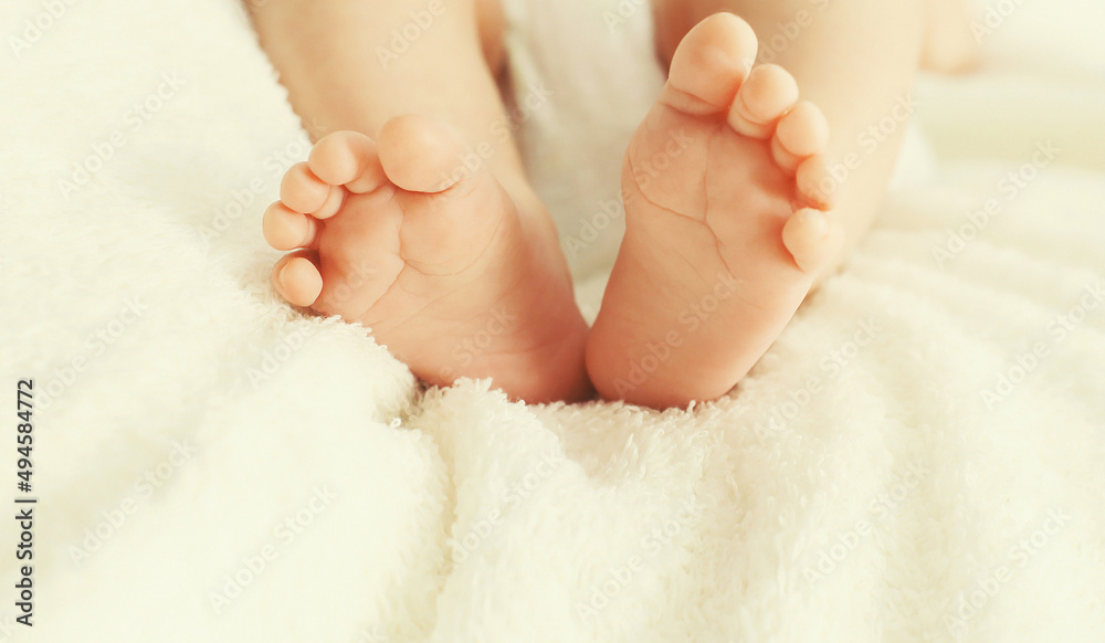 Close up image of baby feet on the bed at home Close up image of baby feet on the bed at home