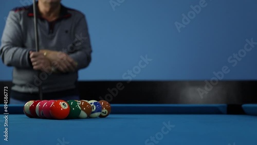 A pool table. Parts of a pool table close-up. American pool table. Billiard balls. Billiard balls in the table with blue surfaces. Billiard player wiats to play photo