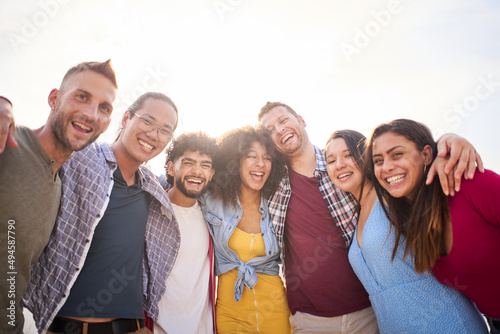 Happy group of friends taking smiling selfie outdoors. Friendship concept on young people enjoying time together and having fun.
