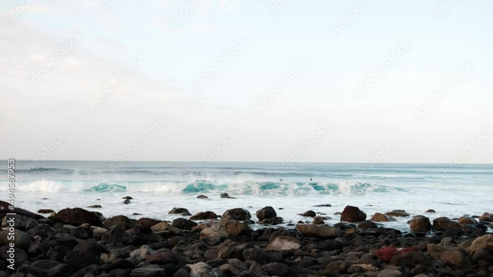 Serfers on a ocean wave on sunset, Atlantic Ocean Serfers on a ocean wave on sunset, Atlantic Ocean