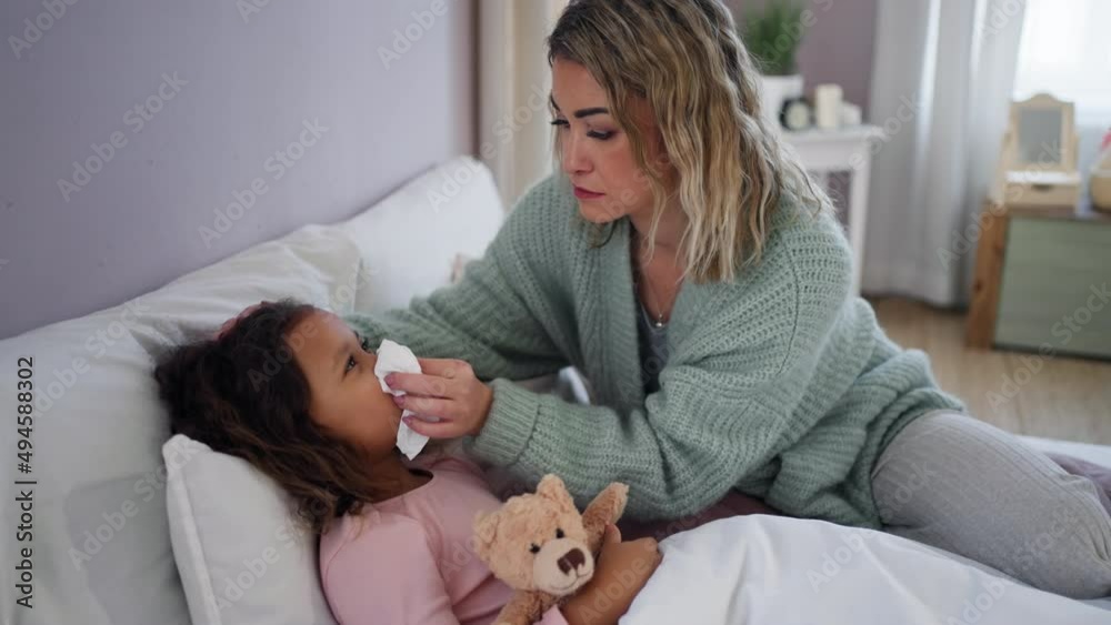 Mother taking care of her ill daughter at home. Mother taking care of her ill daughter at home.