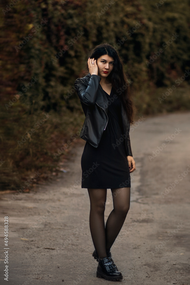 Girl in a black dress and black leather jacket Girl in a black dress and black leather jacket