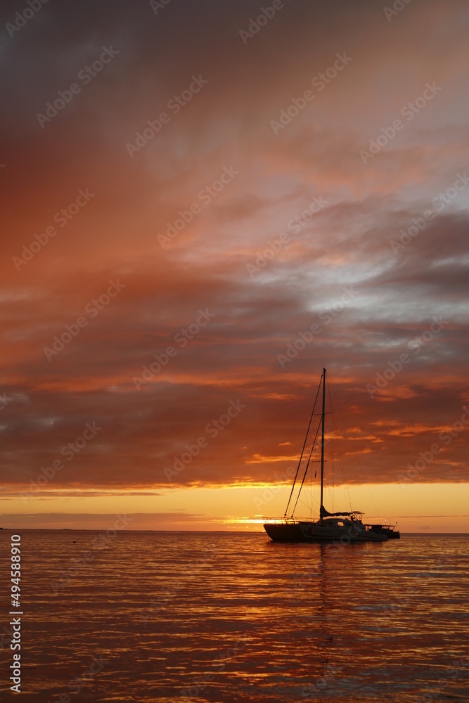 sunset in Hawaii with sailboat