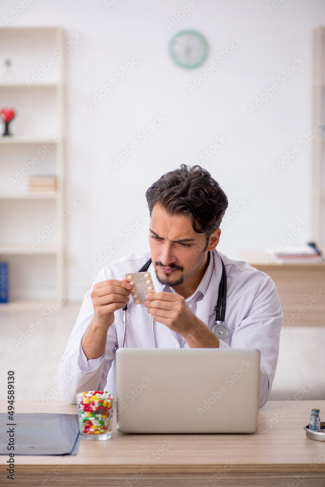 Young male doctor working in the clinic Young male doctor working in the clinic