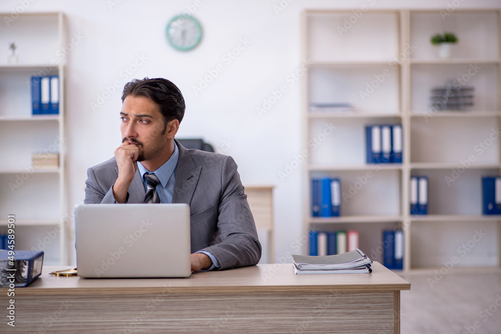 Young male employee working in the office