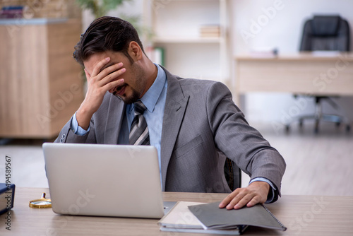 Young male employee working in the office