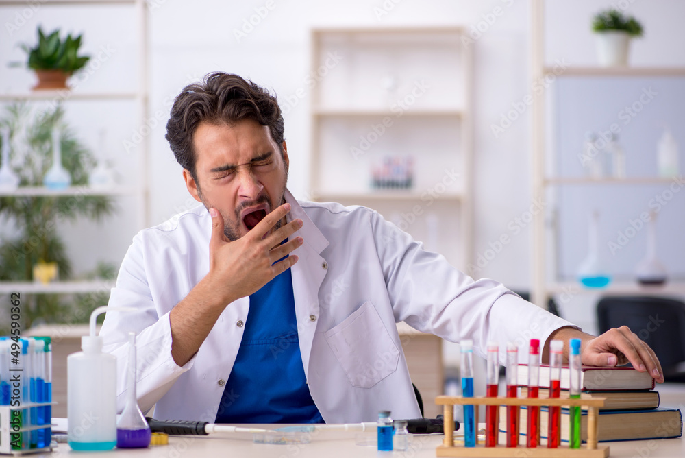 Young male chemist working at the lab Young male chemist working at the lab
