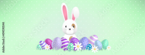 a cute white bunny behind colored eggs and flowers on a green background