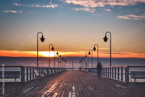 Fototapeta Naklejka Na Ścianę i Meble -  Beautiful morning seaside landscape. Wooden pier with a colorful sky in Gdynia Orlowo, Poland.