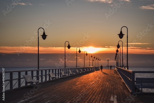 Fototapeta Naklejka Na Ścianę i Meble -  Beautiful morning seaside landscape. Wooden pier with a colorful sky in Gdynia Orlowo, Poland.
