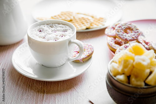 cup of fresh aromatic homemade hot chocolate or cacao served for breakfast at home on pink background