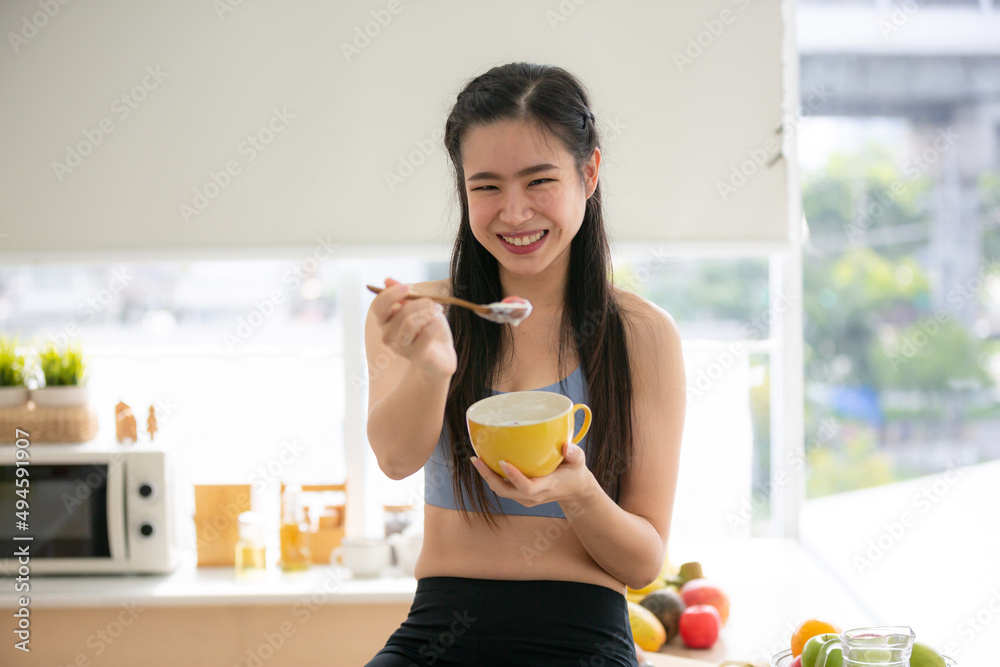 young Asian woman cooking vegetable healthy food and eating or drinking in home kitchen young Asian woman cooking vegetable healthy food and eating or drinking in home kitchen