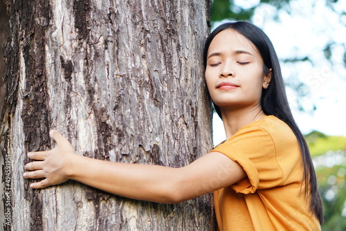 Asian women huging trees , the concept of love for the world