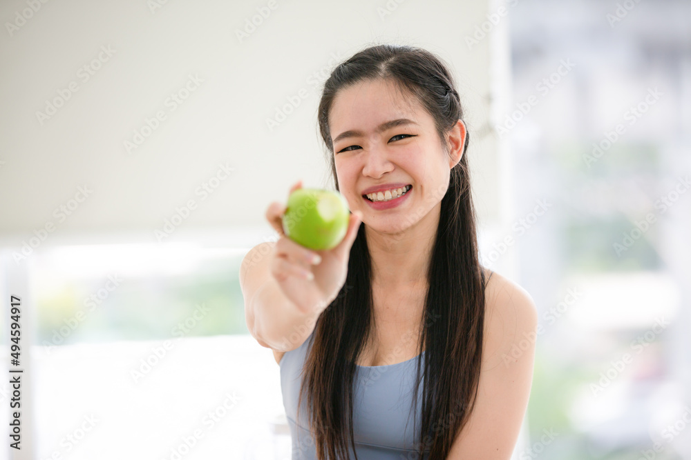 young Asian woman cooking vegetable healthy food and eating or drinking in home kitchen young Asian woman cooking vegetable healthy food and eating or drinking in home kitchen