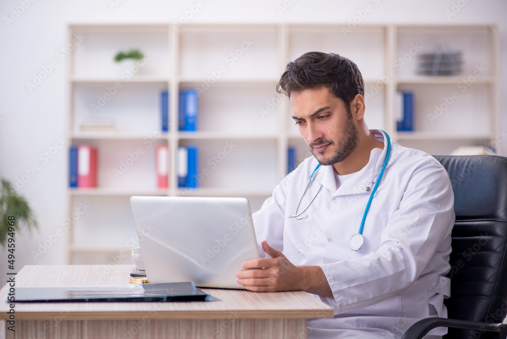 Young male doctor working in the clinic Young male doctor working in the clinic