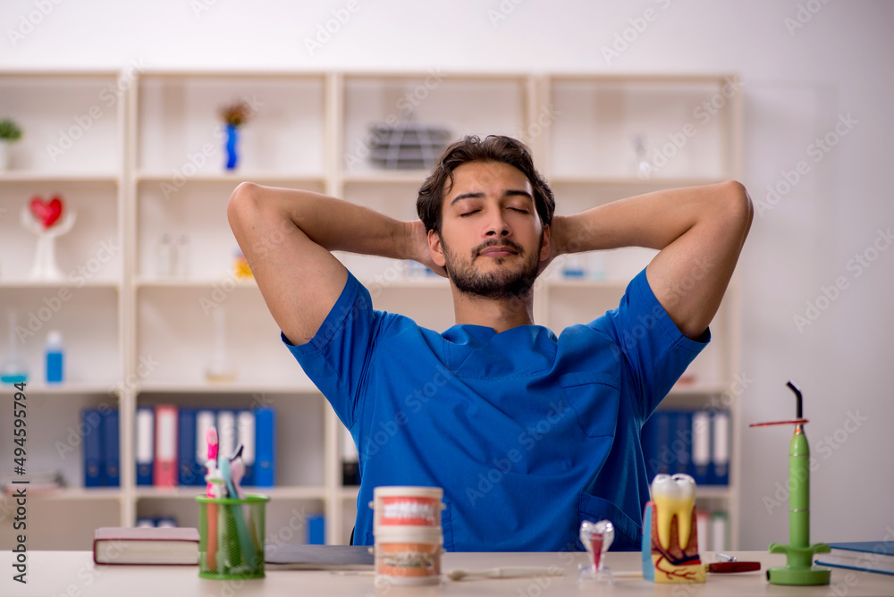 Young male dentist working in the clinic Young male dentist working in the clinic