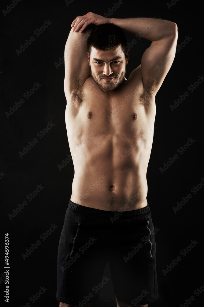 Your limits are smaller than you think so keep pushing. Studio portrait of a sporty young man stretching his arms isolated on black. Your limits are smaller than you think so keep pushing. Studio portrait of a sporty young man stretching his arms isolated on black.
