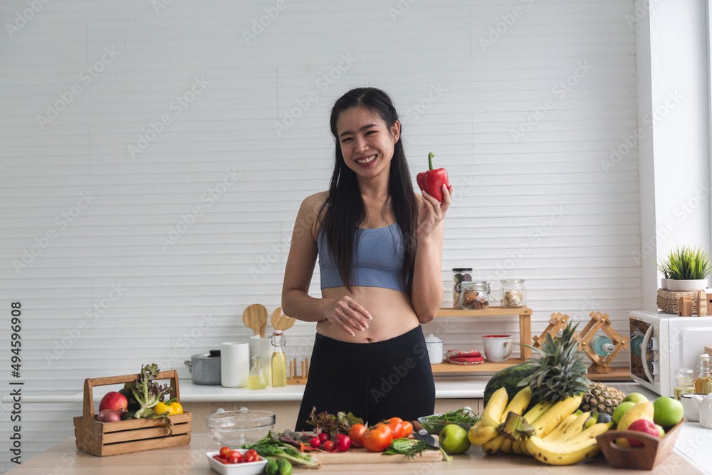 young Asian woman person cooking in kitchen with a healthy food concept, drink and organic vegetable young Asian woman person cooking in kitchen with a healthy food concept, drink and organic vegetable