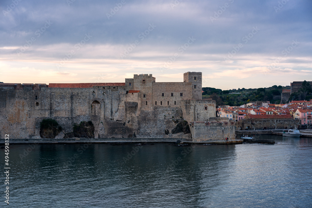 Collioure city view with colorful buildings and royal castle at sunset, in France