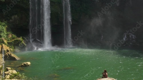 Female Tourist Enjoing the View of Misoh-Ha Waterfall in Chiapas, Mexico photo