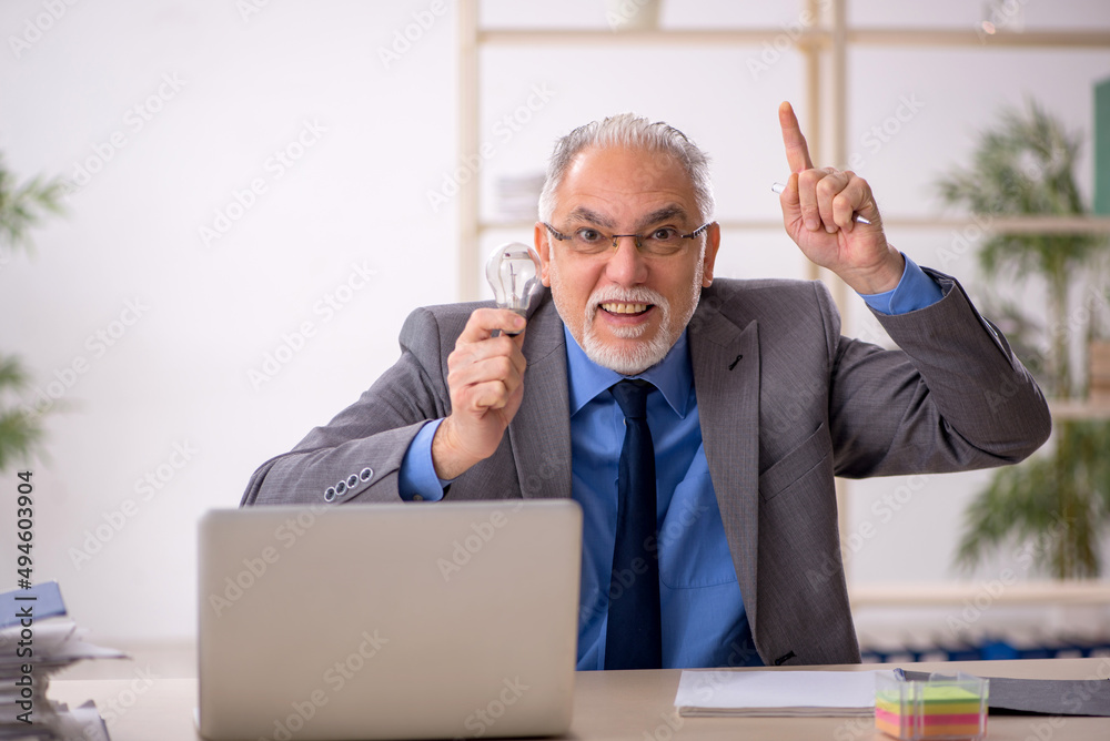 Old male employee in happy idea concept Old male employee in happy idea concept