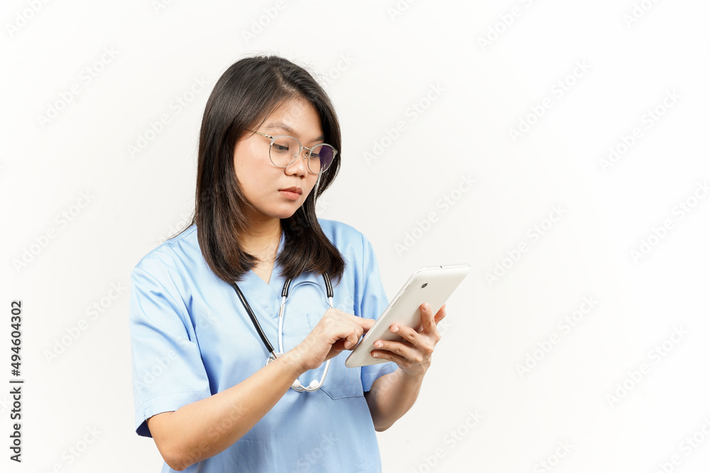 Holding and Using Tablet Of Asian Young Doctor Isolated On White Background Holding and Using Tablet Of Asian Young Doctor Isolated On White Background